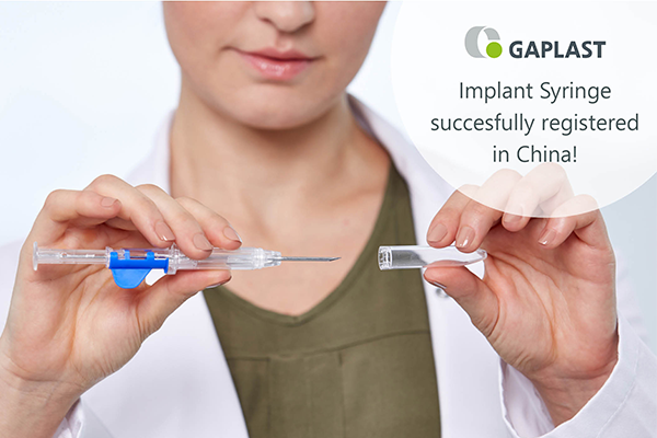doctor removes protective cap from implant syringe